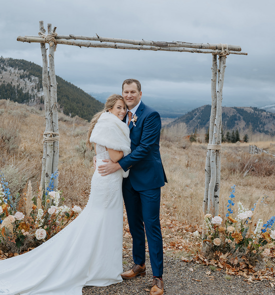 Fall wedding ceremony at Spring Creek Ranch in Jackson Hole, Wyoming. Fall colors of rust, blush, ivory and a touch of blue surrounding the aspen arbor. Dandelion Floral - florist