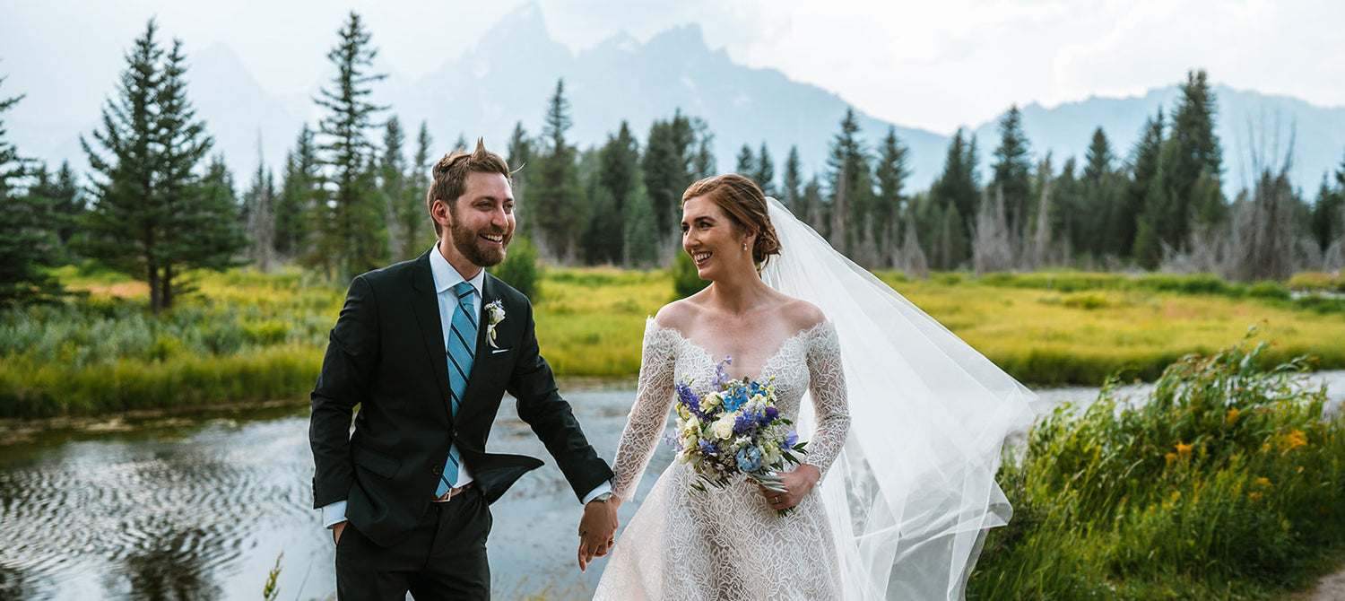 Bride and groom at Schwabacher Landing with view of Tetons. Jackson Hole wedding florist, Dandelion Floral
