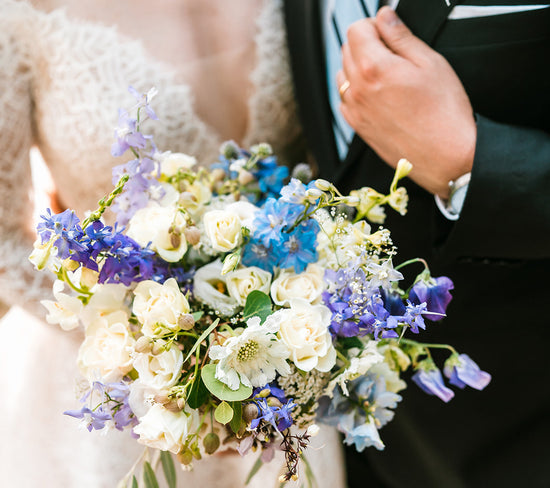 Blue, white, and purple bridal bouquet July wedding at Schwabacher's landing in grand Teton national park